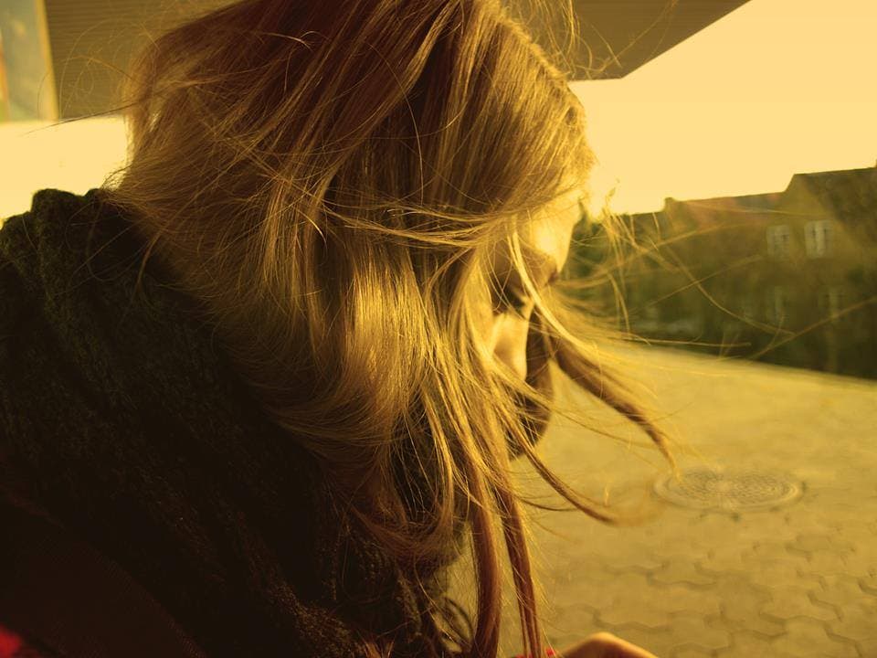 Martina, founder of ProfsHub AI, in warm golden light with wind-blown hair